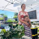 Jennifer Unruh and daughter Claire enjoy at day at the familys Jembe Farms at the Sequim Farmers & Artisans Market on 
June 26. Photo by Emma Jane Garcia