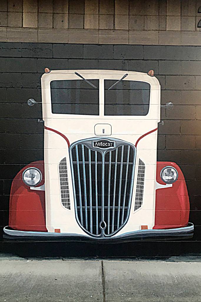 Mural artist Andy Eccleshall said his depiction of a 1937 AUTOCAR could turn some heads as people drive by because he believes they may think its real next to East Washington Street. Sequim Gazette photo by Matthew Nash