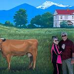 Judy and Bob Stipe stand underneath Andy Eccleshalls depiction of the Dungeness Schoolhouse. Judy Stipe said Eccleshall is a renaissance man and such a delight to work with. (The mural) is a beautiful thing for all of us who have seen this place grow, she said. Photo courtesy Katherine Vollenweider