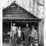 A group of people  from left, Chester Chet Jay Howser, Margie Belle Walton Howser, Grant Warren Humes with his dog Bing, and Phyllis Henerietta Walton Anderson Young  enjoy some time at the Humes Ranch in March 1926. North Olympic Heritage/Bert Kellogg Photograph Collection