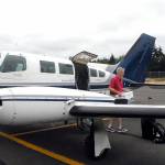 Aspiring Dash pilot Josh Crabtree of Port Angeles unloads boxes of maintenance records from a Dash Air Shuttle Cessna 402C on Wednesday, June 30, at William R. Fairchild International Airport in Port Angeles. Photo by Keith Thorpe/Olympic Peninsula News Group