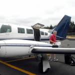 Aspiring Dash pilot Josh Crabtree of Port Angeles unloads boxes of maintenance records from a Dash Air Shuttle Cessna 402C on Wednesday, June 30, at William R. Fairchild International Airport in Port Angeles. Photo by Keith Thorpe/Olympic Peninsula News Group
