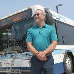 Clallam Transit General Manager Kevin Gallacci stands in front of a Route 20 bus last week. The route will see expanded service, including Peninsula College and Olympic Medical Center. Photo by Keith Thorpe/Olympic Peninsula News Group