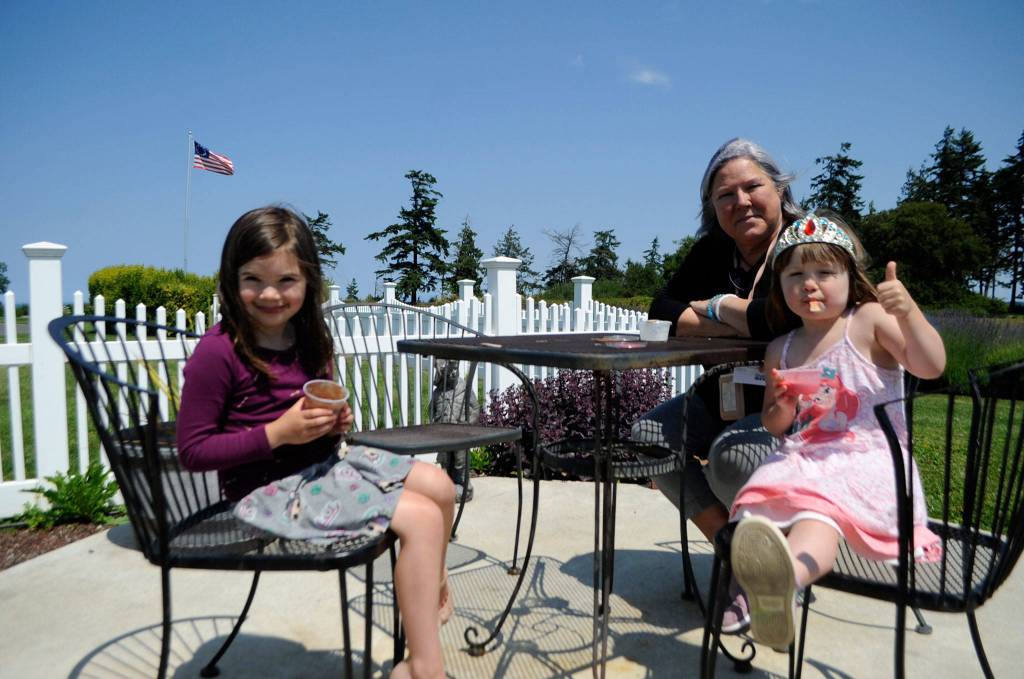 Joy Neal, who lives near Washington Lavender Farm and the George Washington Inn, enjoys some lavender ice cream with her granddaughters Summer, 6, and Sloane, 3, Smith last week.