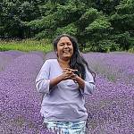 Krishnaveni Cheruvu, owner of Martha Lane Lavender Farm, stands in a field of lavender at her farm. Her farm is open through the summer each day 9 a.m.-6 p.m. Photo courtesy of Sally Franz
