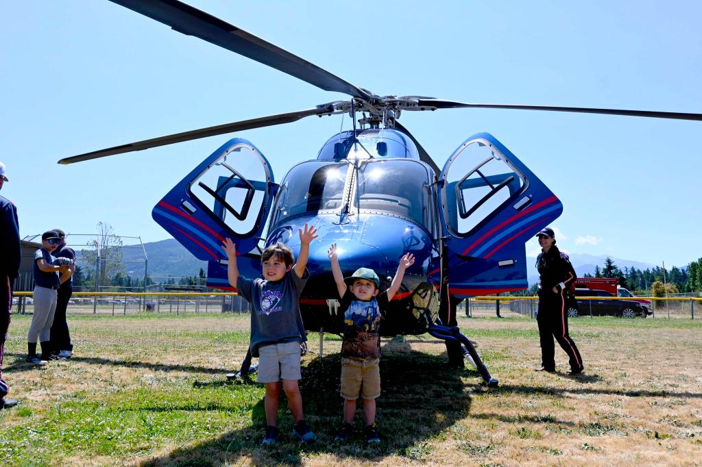 Bryson Yanik, 5, at left, and his 3-year-old brother Wylie enjoy checking out the Life Flight Network helicopter at Sequim Little Leagues 2021 season-ending ceremonies on July 10. Sequim Gazette photos by Michael Dashiell