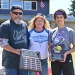 Sequim Little League softballer Mia Kirner, right, accepts the Don Knapp Sportsmanship Award from Tony and Brenda Knapp Bistline on July 10 at the leagues season-ending ceremonies. In part to honor the legacy of longtime volunteer/advocate Don Knapp, who passed away in November 2020, the league created the sportsman ship award for one baseball player and one softball player. Kirner and baseballer Bryant Laboy (who received the award at a separate ceremony) are the first recipients.