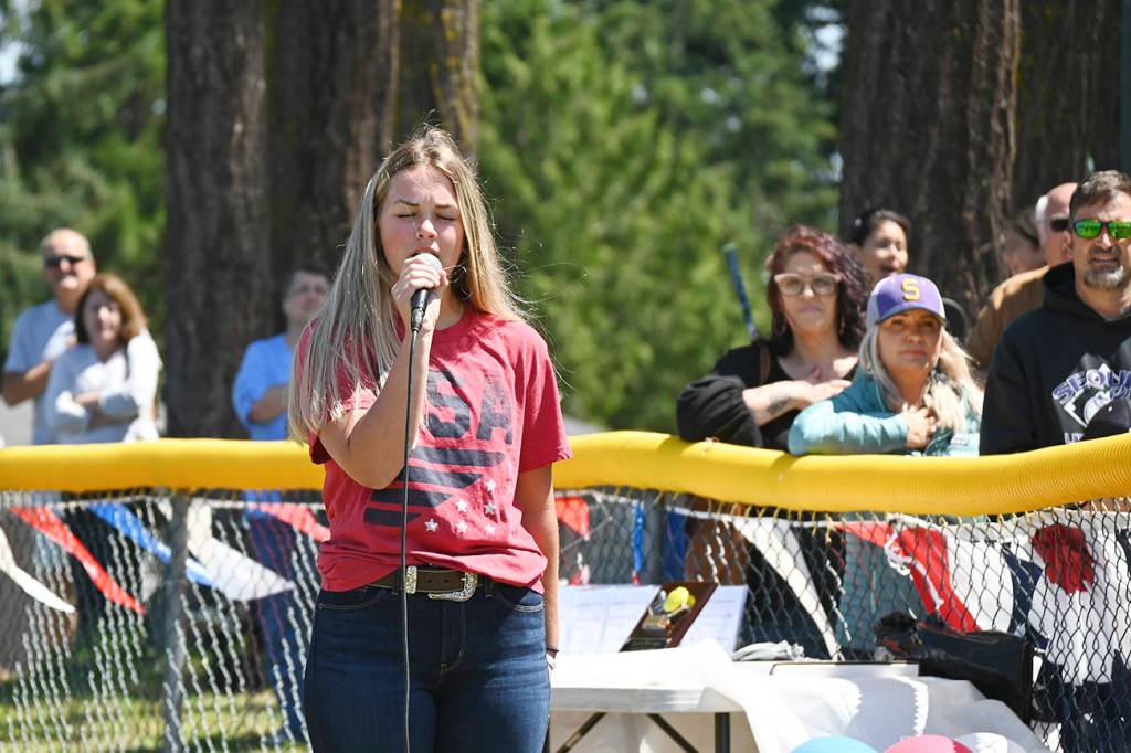Michaela Green sings the National Anthem at Saturdays Little League season-closing ceremonies.