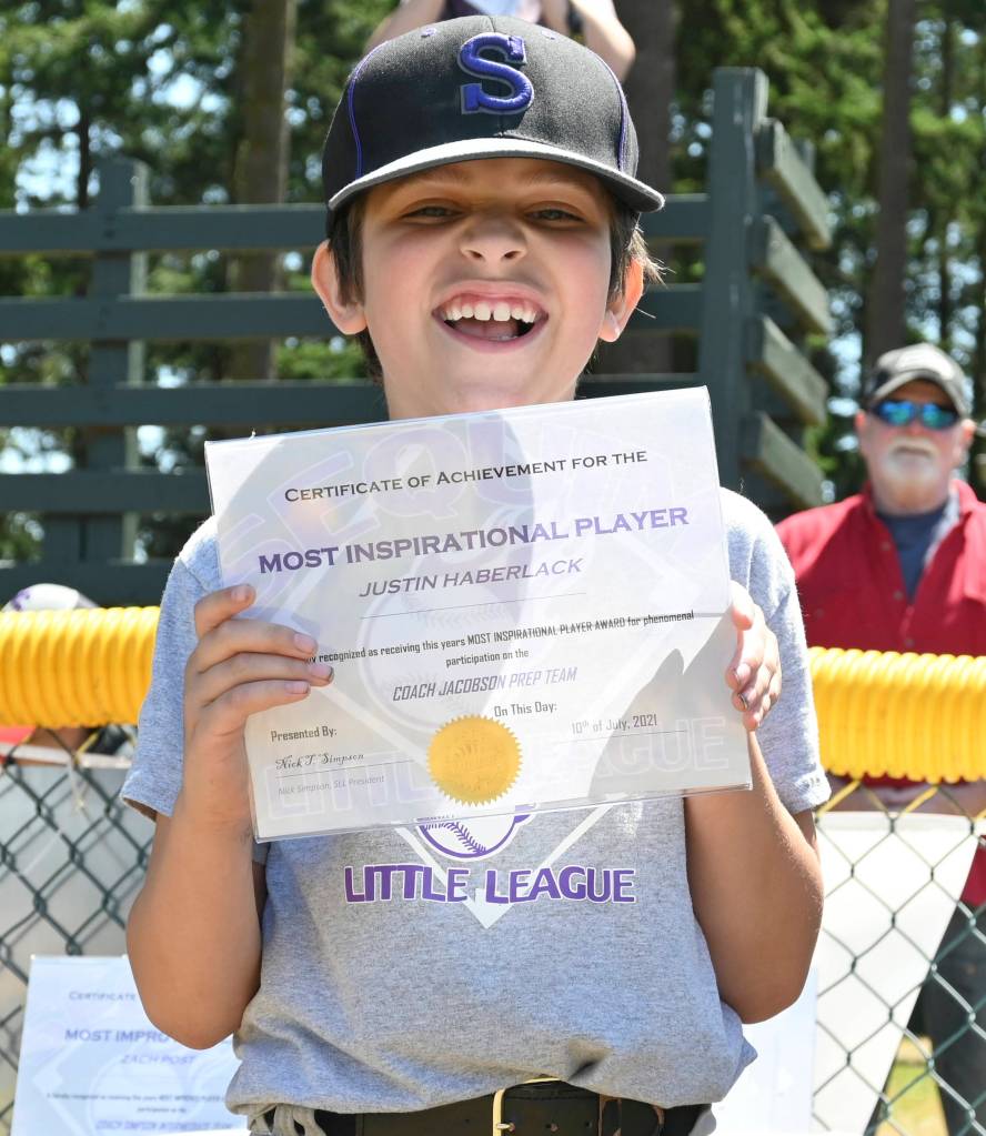 Justin Haberlack is all smiles after receiving his Sequim Little League prep division teams Most Inspirational Player Award on Saturday afternoon.