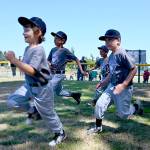 Sequim Little League players race onto Don Knapp Field as part of the season-closing ceremonies on July 10. Sequim Gazette photo by Michael Dashiell