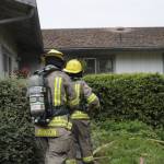 Firefighters on July 14 access a home on the 1000 block of West Palo Verde Loop to make sure a fire is extinguished. Sequim Gazette photo by Matthew Nash