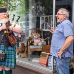 Erik Evans, the Parking Lot Piper, enjoys a moment with Gary Stachurski of Cedarbrook Lavender & Herb Farm last week. Sequim Gazette photo by Emily Matthiessen