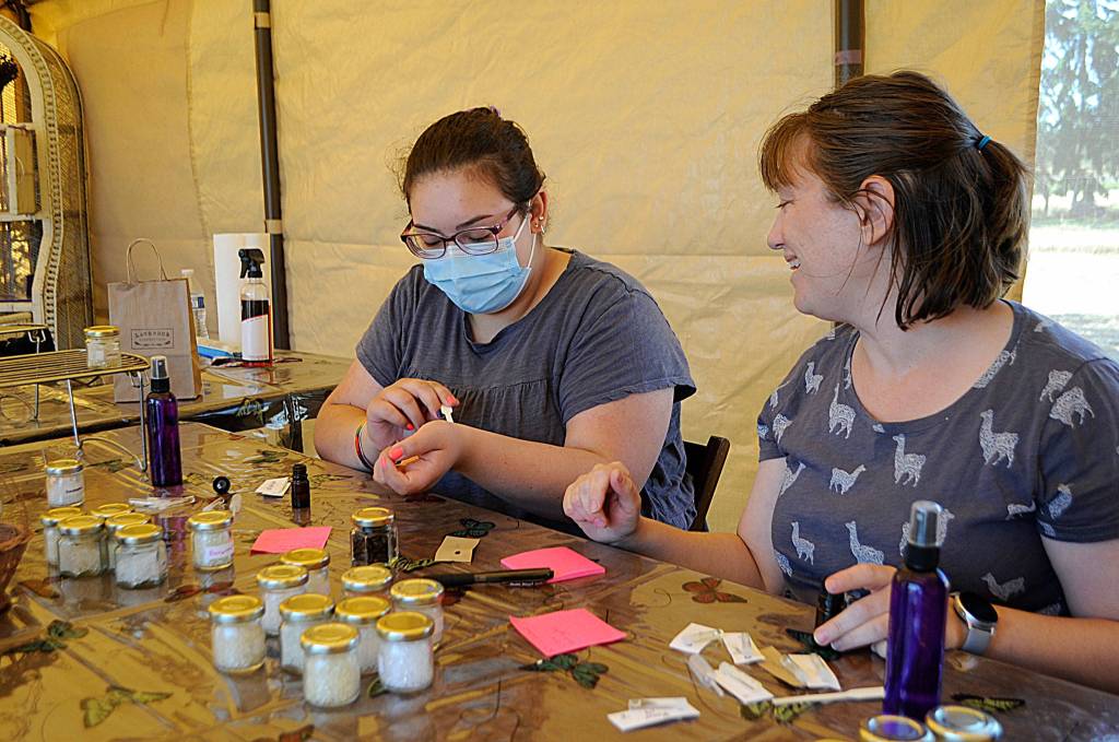 Ellie Restrepo tests a lavender fragrance with her aunt Carla Smith of Arlington at Lavender Connection as they make lavender sprays together. The family members said it was their first time experiencing Sequim Lavender Weekend and they visited farms on July 17-18. Sequim Gazette photo by Matthew Nash