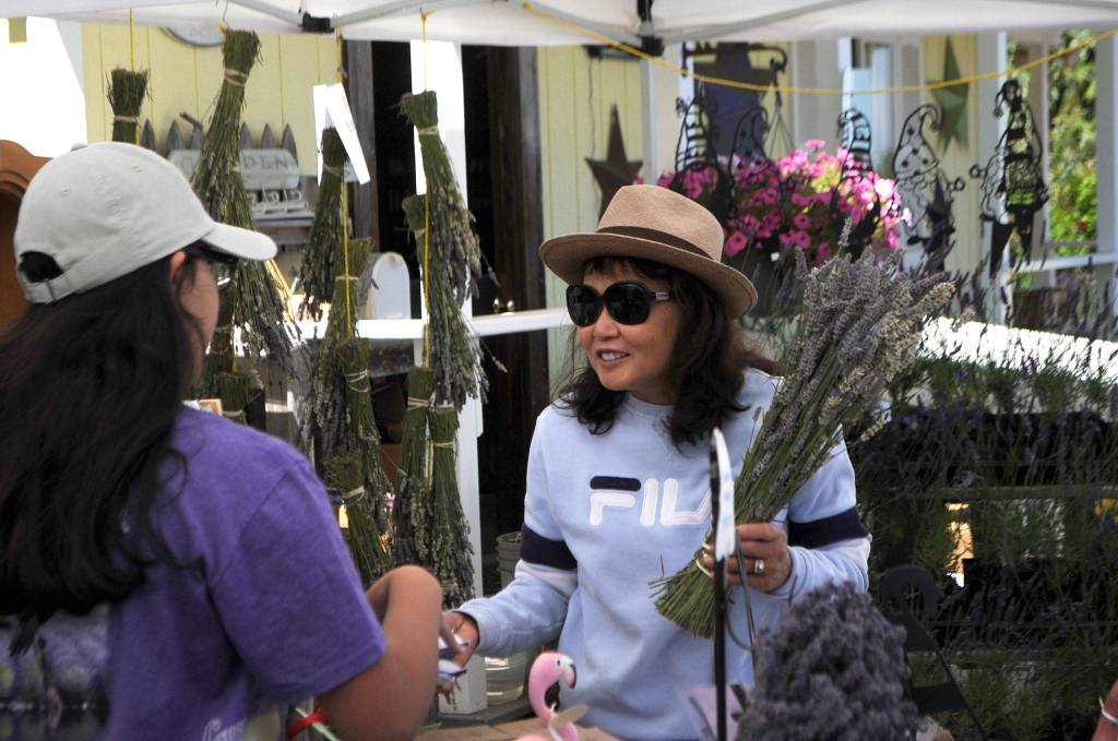 Tanya Manley talks with Ali Edgecombe about lavender products at Nelsons Duckpond & Lavender Farm on July 18. Manley said she and her husband James split time between Tacoma and Sequim and love the area and hope to move here permanently next year. Sequim Gazette photo by Matthew Nash