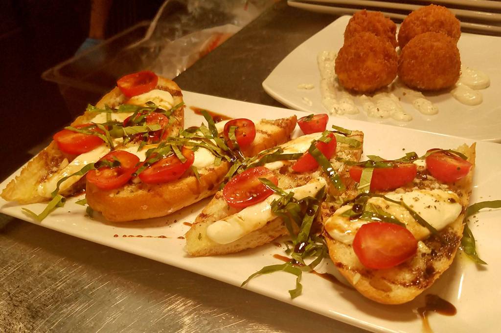 Caprese French Bread Pizza and Mack Bites (deep fried macaroni and cheese with a little bit of heat and potato chip breading) are some of the appetizers available at Shadowline Burgers and Brews. Photo courtesy of Shadowline Burgers and Brews