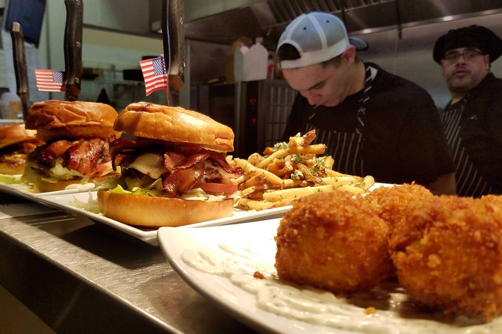 Cook Tyler Tegoseak and Head Chef Mark Diaz prepare multiple meals, including a few elevated burgers at Shadowline Burgers and Brews. Photo courtesy of Shadowline Burgers and Brews