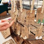 Above: Farmer-turned-artisan Erica Harris applies a natural chemical reaction to the surface of some of her raw brass pieces that highlights some brilliant tones of turquoise, greens and browns. Right: Harris brings her creative eye to offer wearable art at the Wheat Stalk Boutique booth, featured at the Sequim Farmers and Artisans Market this summer. Photos by Emma Jane EJ Garcia
