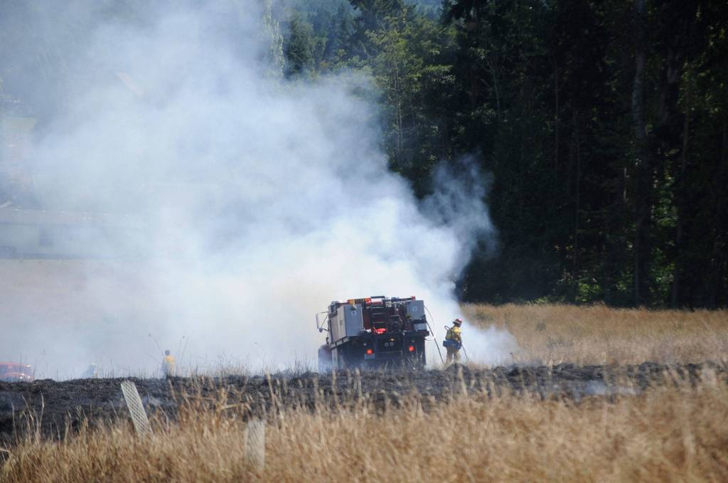 Fire officials estimate more than five acres was burned in a brush fire on July 27. Sequim Gazette photo by Matthew Nash