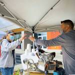 Essence Coffee Roasters Rod Dirks hands a customer their coffee at the Sequim Farmers & Artisans Market. Photo by Emma Jane EJ Garcia