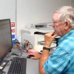 Clallam County election worker Daniel Cain of Sequim consults a database of signatures to verify ballots on Aug. 3 at the courthouse in Port Angeles. Photo by Keith Thorpe/Olympic Peninsula News Group