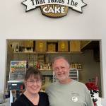 Sue and Paul Boucher of That Takes the Cake in Sequim show off their Olympic Peninsula Tourism Commission Share campaign buttons. Photo courtesy of Olympic Peninsula Tourism Commission