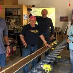 Sequim Sunrise Rotarians, from left, Jack Tatom, Chris Coolures, Ron Long and Rich Benn paint and prep new coat hangers for the Sequim Boys & Girls Club last week. Photo courtesy of Ann Flack