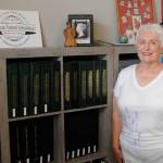 Since she was a girl, Vera Felts, seen standing by her collection of different countrys stamps, said stamps opened up a new world to her. Now shes exhibiting for the first time about lavender stamps at the Strait Stamp Show on Aug. 21 in the Guy Cole Event Center. Sequim Gazette photo by Matthew Nash