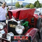 Wayne Caldwell of Sequim, second from left, discusses his Stutz sports car, a 1927 AA Black-Hawk boat-tail two-passenger speedster, with attendees of the Sequim Prairie Nights event in downtown Sequim Saturday. Sequim Gazette photos by Michael Dashiell