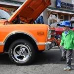 Isaiah Wage, 3, of Sequim, enjoys a low-level view of classic cars at the Sequim Prairie Nights show-and-shine Aug. 7.