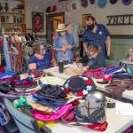 On Aug. 9, organizers, including Richard Stephens, director, of OTAs Kings, Queens and Royal Scenes Renaissance Faire touch base at the end of a day of preparation at Olympic Theatre Arts in Sequim. They are surrounded by potential costumes for auxiliary actors to choose from to wear as they participate in the OTAs Renaissance Faire. Sequim Gazette photo by Emily Matthiessen