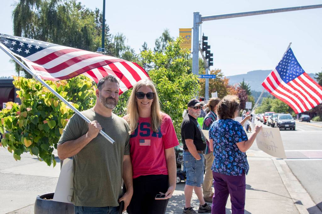 Gary and Lisa Rocha attend the vaccine mandate protest in downtown Sequim because, We support medical freedom, Lisa said. America is about freedom of choice, Gary said. Sequim Gazette photo by Emily Matthiessen