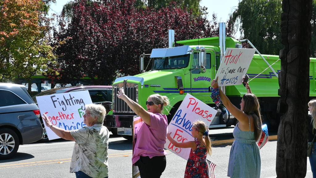 Protestors cheer after getting encouraging honks from drivers at the intersection of Washington Street and Sequim Avenue on Aug. 18. Sequim Gazette photo by Michael Dashiell