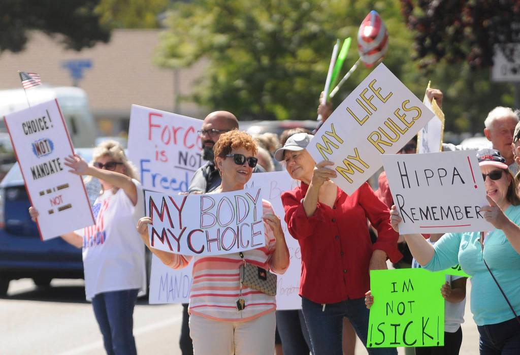 More than 100 protestors fill the corners of Washington Street and Sequim Avenue on Aug. 18. Sequim Gazette photo by Michael Dashiell