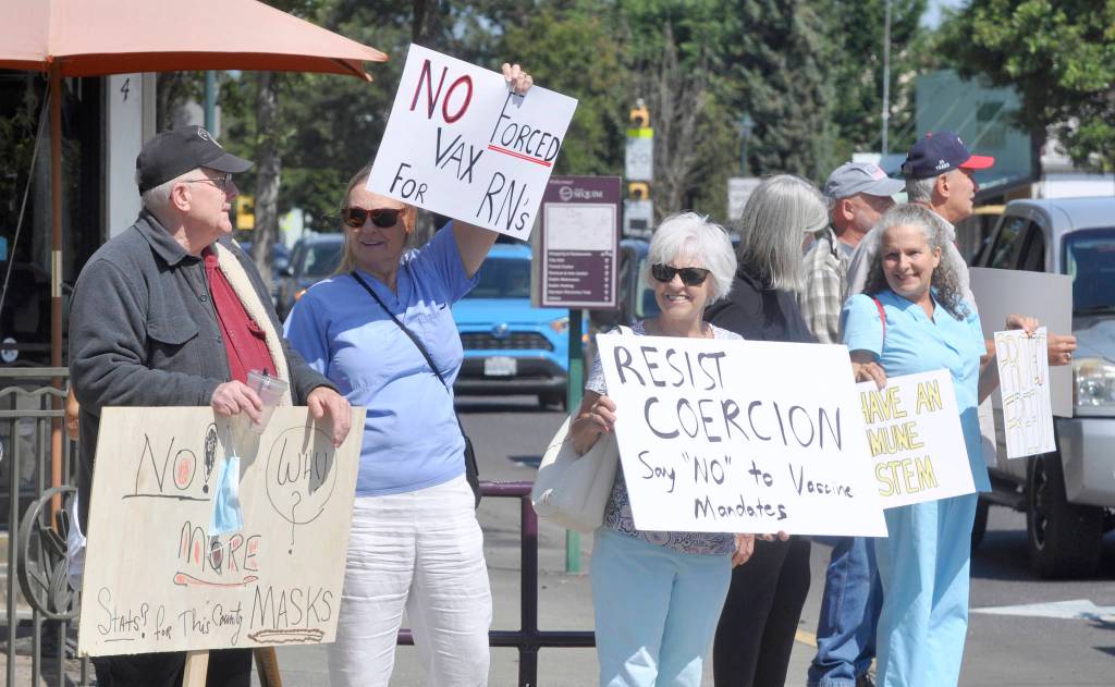 More than 100 protestors fill the corners of Washington Street and Sequim Avenue on Aug. 18. Sequim Gazette photo by Michael Dashiell