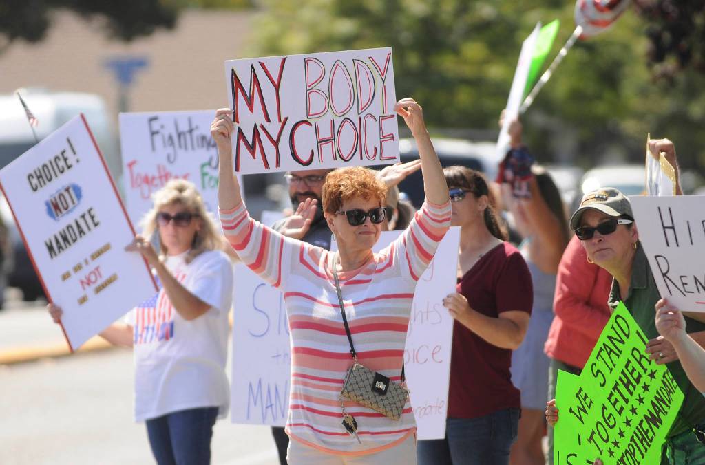 More than 100 protestors fill the corners of Washington Street and Sequim Avenue on Aug. 18. Sequim Gazette photo by Michael Dashiell