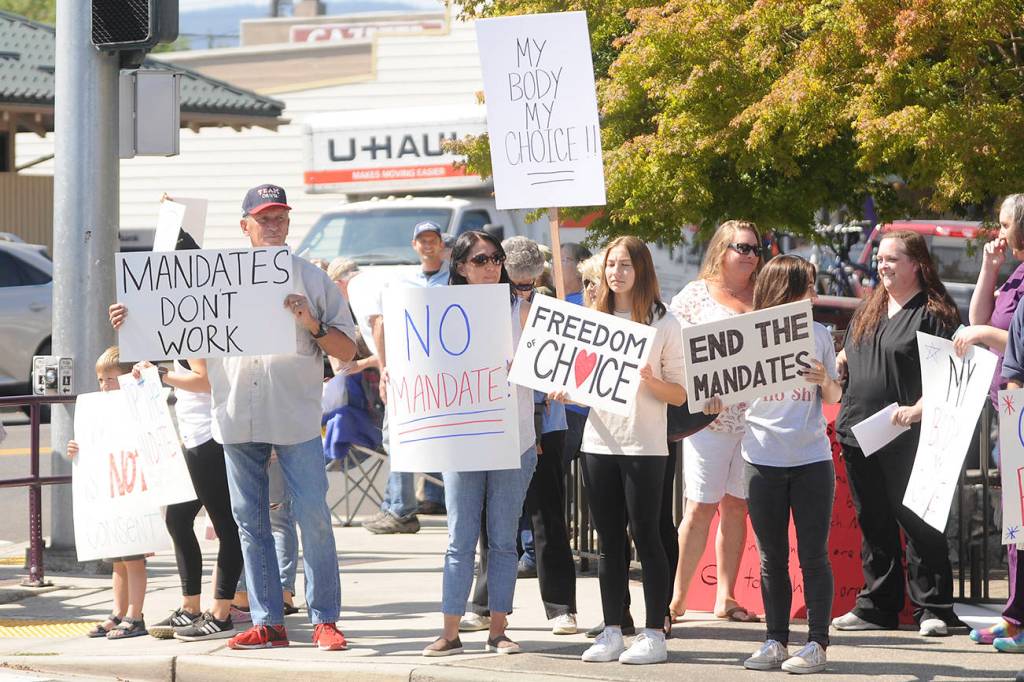 More than 100 protestors fill the corners of Washington Street and Sequim Avenue on Aug. 18. Sequim Gazette photo by Michael Dashiell