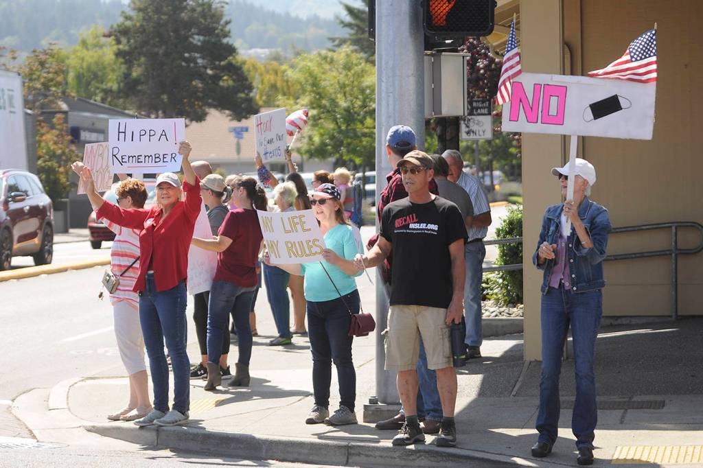 More than 100 protestors fill the corners of Washington Street and Sequim Avenue on Aug. 18. Sequim Gazette photo by Michael Dashiell