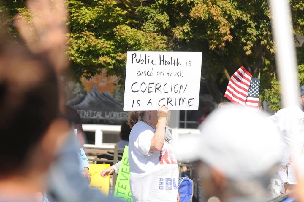 More than 100 protestors fill the corners of Washington Street and Sequim Avenue on Aug. 18. Sequim Gazette photo by Michael Dashiell