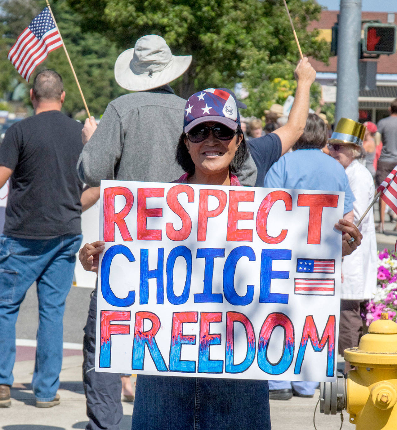 Chadley Klinger holds a handmade sign at the intersection of Sequim Avenue and Washington Street on Aug. 18, protesting the vaccine mandate for healthcare workers. I dont think that peoples livelihoods should be threatened by how they take care of their bodies, Klinger said. Sequim Gazette photo by Emily Matthiessen