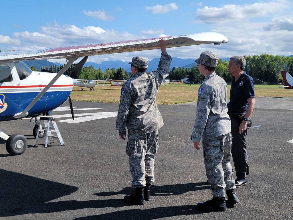 Cadets Joseph Maggard of Port Angeles and Reilly Sue of Sequim test aircraft aileron as Captain John Weidman of Bremerton looks on. Submitted photo