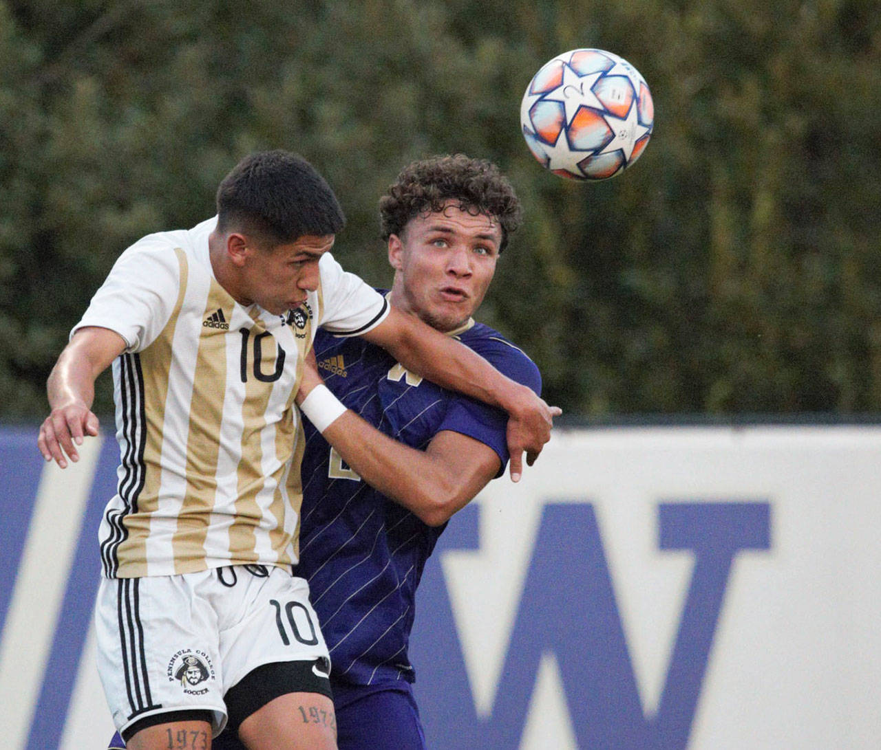 Peninsula Colleges Edgar Tavares, left, challenges University of Washingtons Kendall Burks for the ball in an Aug. 15 scrimmage in Seattle. Photo by Rick Ross/Peninsula College