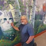 Port Angeles artist Dave Montague works on a mural at the Olympic Peninsula Humane Societys McKay Kitty City near Sequim. When I heard about the new Kitty City building, I really wanted to help, Montague said. I decided to offer my services to create a mural to capture the cats personalities that will live there until adopted. Since I am an avid hiker, I wanted to depict our furry friends in the scenes I have enjoyed through my 3,000 miles of hiking throughout the Olympic Mountains. Photo courtesy of Olympic Peninsula Humane Society