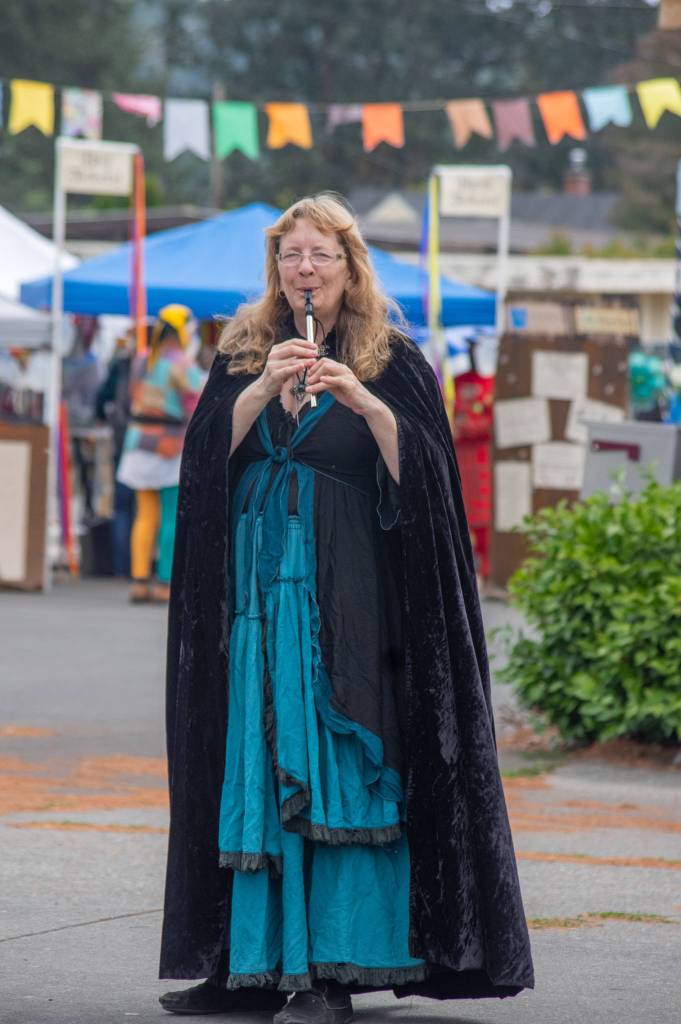 "Jessie the Bard" Christiansen, standing between the parking lot of Sequim Theatre Arts and Sequim Avenue alerts passersby with her penny whistle to the theater's Renaissance Faire on Aug. 22. Sequim Gazette photo by Emily Matthiessen