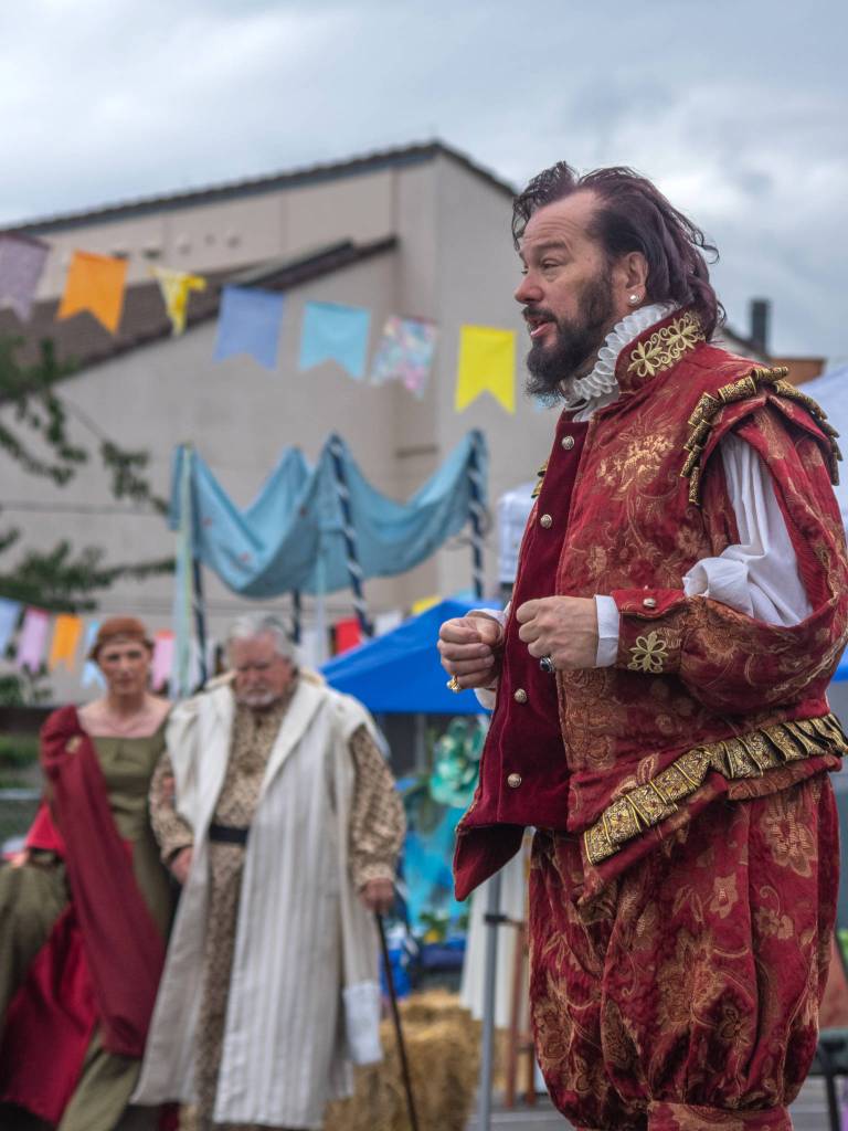 Richard Stephens as Shakespeare speaks to the audience at OTAs Renaissance Faire as Queen Gertrude and her advisor Polonious approach Sequim Gazette photo by Emily Matthiessen