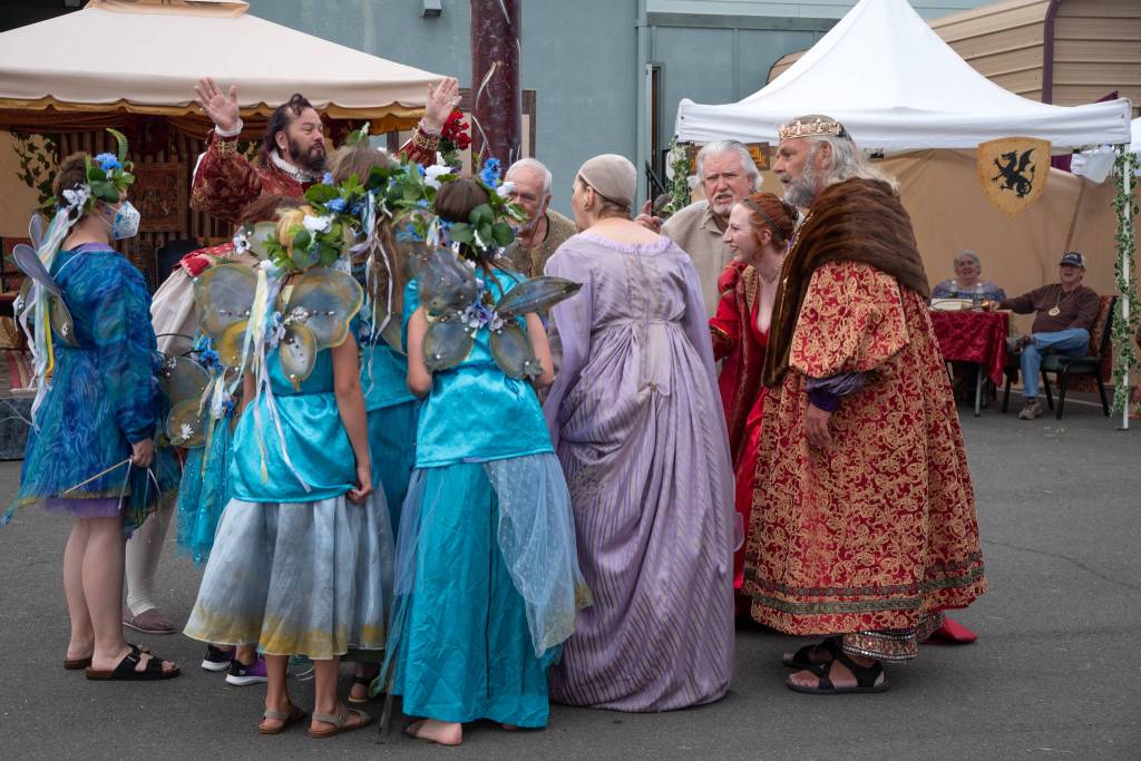 William Shakespeare, played by Richard Stephens, comforts his actors after being scolded by the queen at OTAs Renaissance Faire in Sequim on Aug. 22 Sequim Gazette photo by Emily Matthiessen