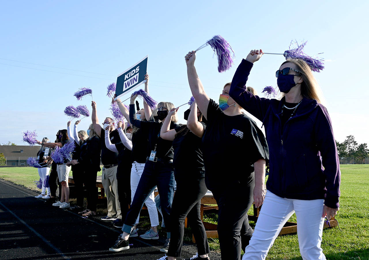 Sequim School District staff lead cheers of Team Sequim, Kids Win at a pre-school year, all-school staff rally on Aug. 23 at the districts sports stadium. The district is planning on welcoming back students for in-person instruction on Wednesday, Sept. 1. Sequim Gazette photo by Michael Dashiell