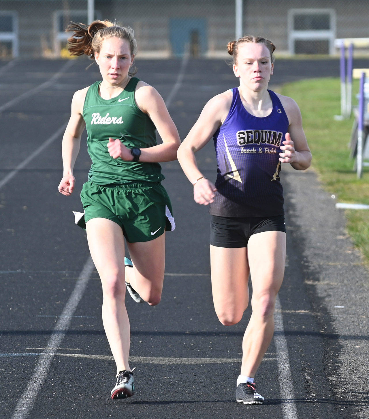 A classic Sequim-Port Angeles match-up that didnt get to shine on the state level last year: PA and Sequim standouts Lauren Larson and Riley Pyeatt go toe-to-toe in the 800-meter race on March 31 in Sequim. The pair competed in same races more than a dozen times, but health restrictions nixed a chance for both to vie for district and state titles in 2020-2021. Larson graduated in 2021, while Pyeatt looks for strong finishes in cross country and track in 2021-2022, her senior year. Sequim Gazette file photo by Michael Dashiell
