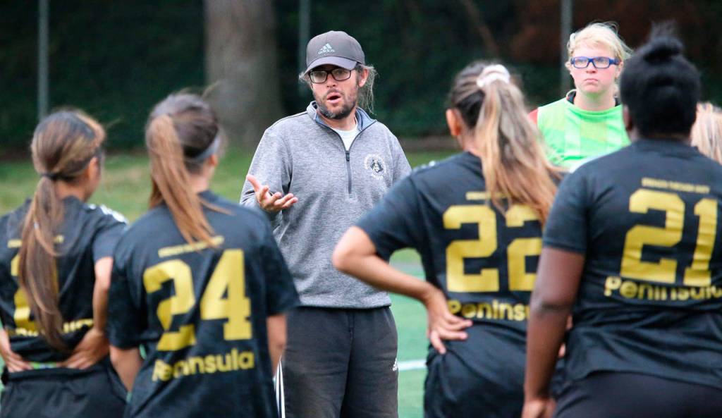 Kanyon Anderson, Peninsula College womens soccer head coach, talks with his players at a preseason friendly against Chemeketa on Aug. 24. The Pirates won in a rout, 11-0. PC is seeking its fifth NWAC title since 2010. Photo by Rick Ross/Peninsula College