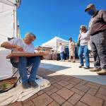 Larry Gonzalez is hard at work Saturday with a new piece of art at the By the Sea Original Artwork booth. Photos by Emma Jane EJ Garcia