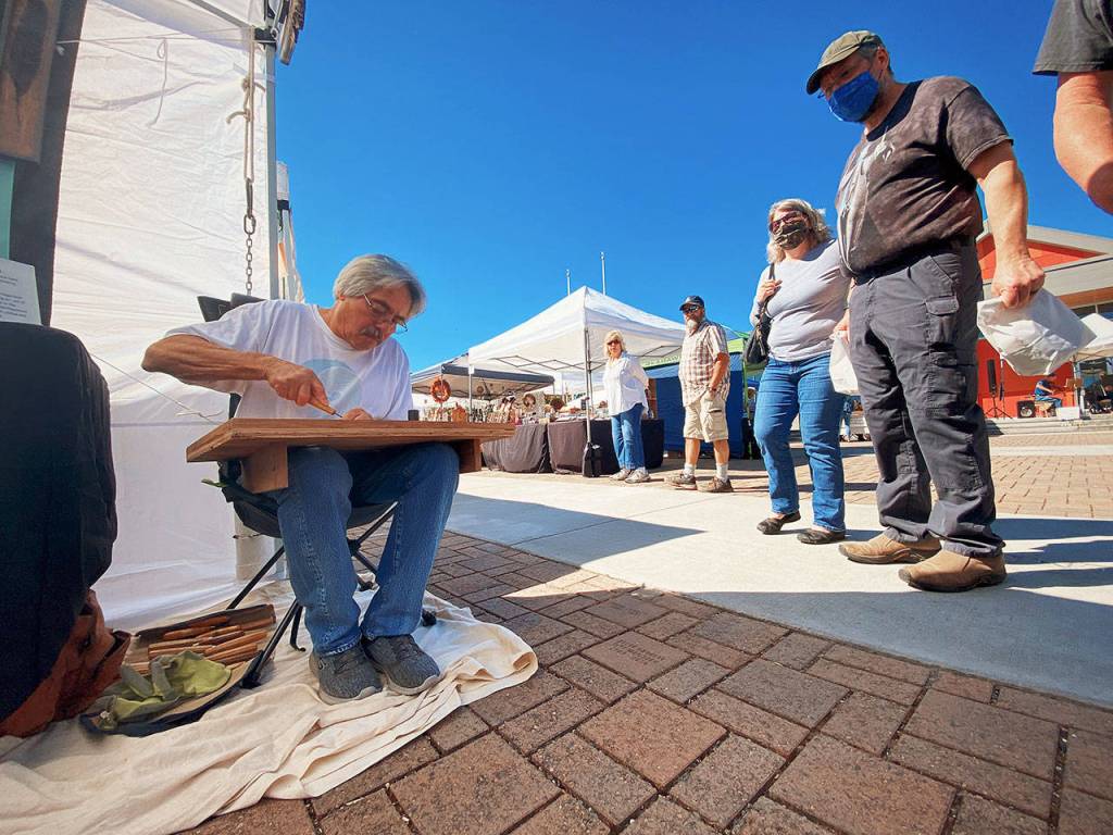 Larry Gonzalez is hard at work Saturday with a new piece of art at the By the Sea Original Artwork booth. Photos by Emma Jane EJ Garcia